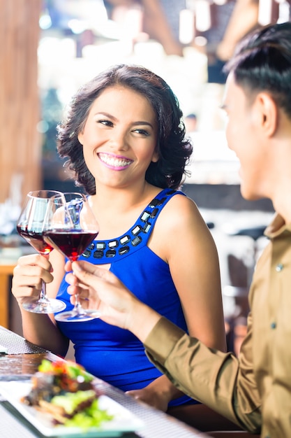 Pareja asiática brindis con vino tinto