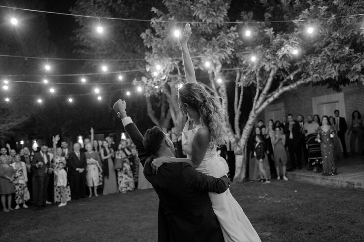 Foto una pareja bailando bajo las luces en una boda