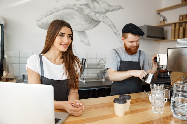 Foto pareja de baristas trabajando en la cafetería.