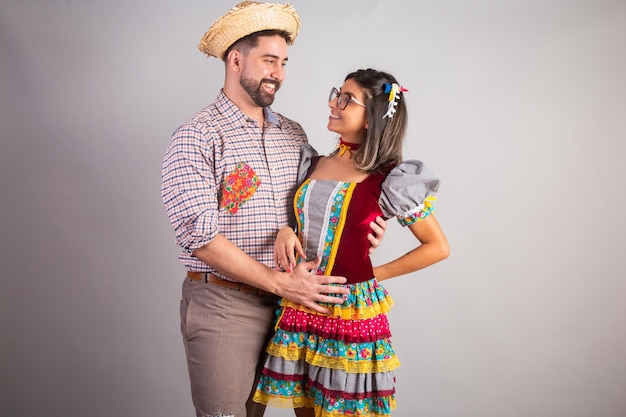 Pareja brasileña vestida con ropa de festa junina fiesta de Sao Joao abrazada