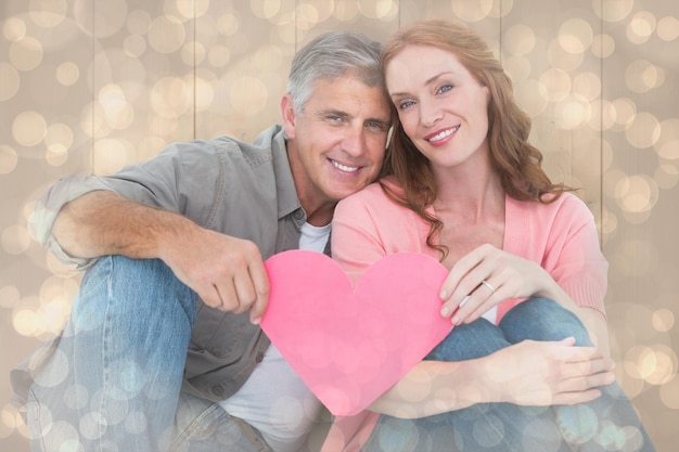 Pareja casual con corazón rosa contra el patrón de diseño de puntos brillantes de luz