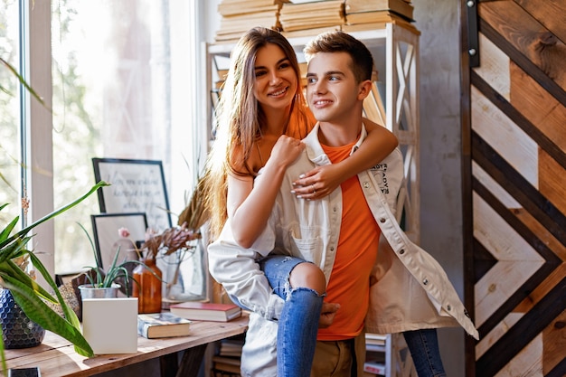 Pareja chico y mujer jugando en la habitación con libros