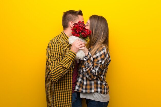 Pareja en el día de San Valentín con flores y besos