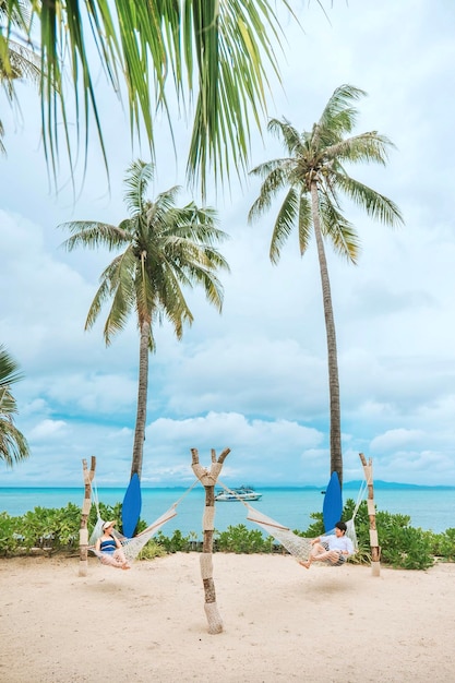 Una pareja disfrutando de unas vacaciones en la playa en un resort tropical con una hermosa piscina costera en el destino de luna de miel al atardecer en Tailandia