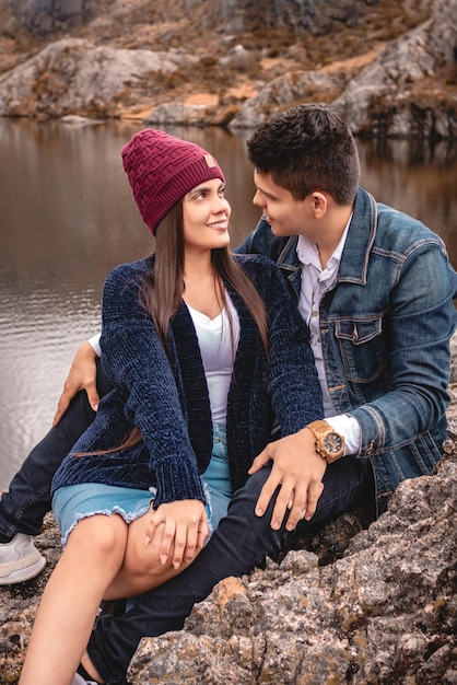 Pareja enamorada mirándose en un paisaje en un lago