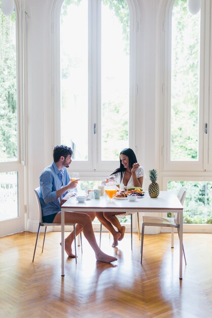 Pareja de enamorados desayunando en la mañana