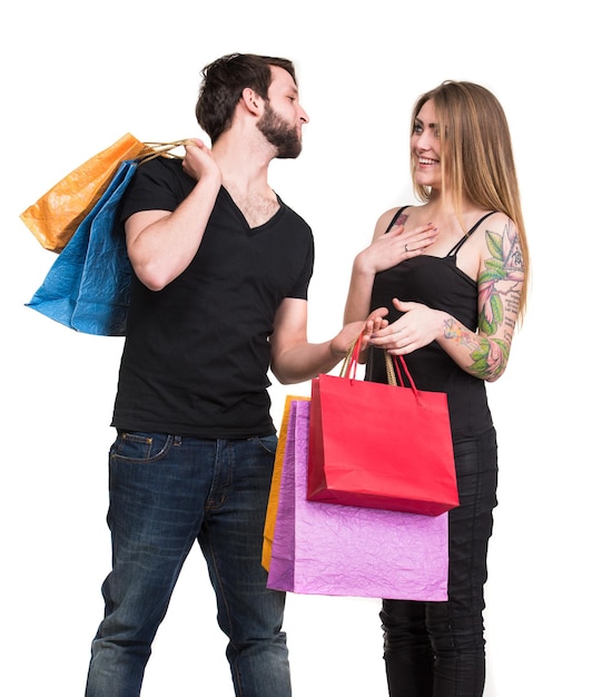 Pareja feliz con bolsas de la compra sobre un fondo blanco.