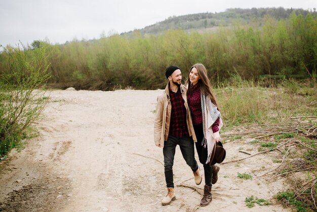 Pareja feliz caminando sobre la naturaleza en las montañas