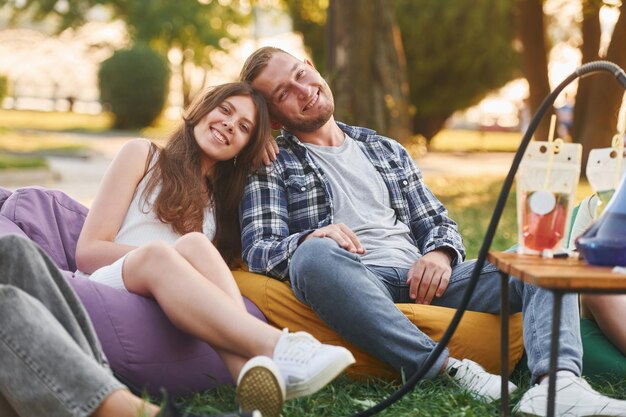 Pareja feliz Grupo de jóvenes tienen una fiesta en el parque durante el día de verano