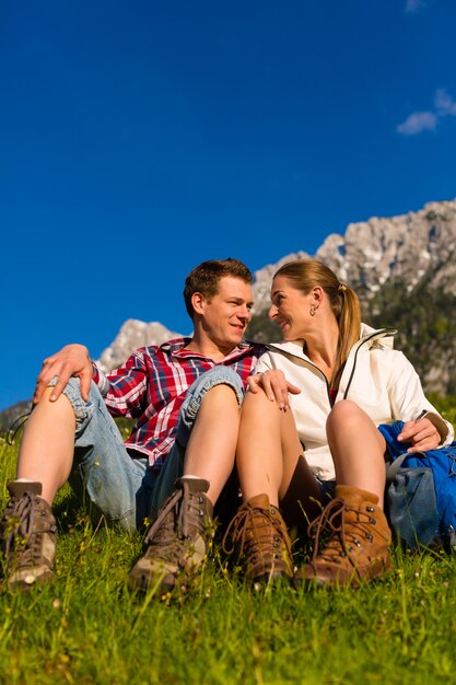 Pareja feliz senderismo en las montañas de los Alpes