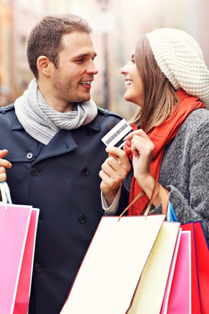 Pareja joven de compras en la ciudad con tarjeta de crédito