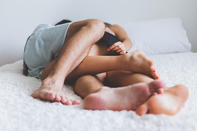 Una pareja joven durmiendo en la cama.