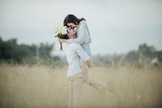 Pareja joven feliz en el romance en el hermoso paisaje de verano