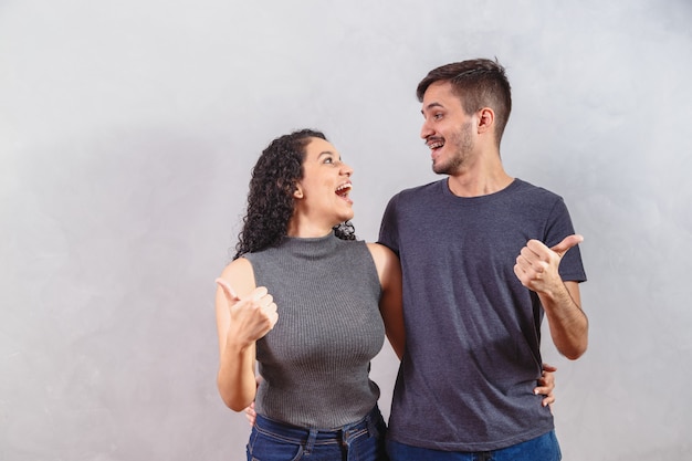 Pareja joven, hacer, ok, señal, en, pared gris