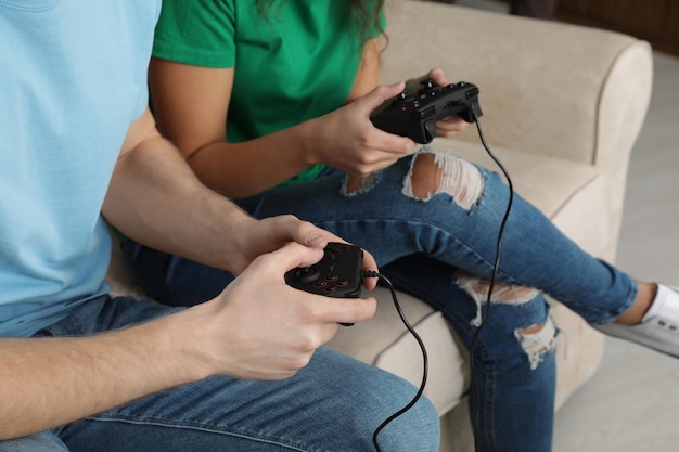 Foto pareja joven jugando videojuegos en casa closeup
