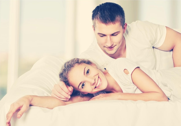 pareja joven, mentira en cama, y, sonriente