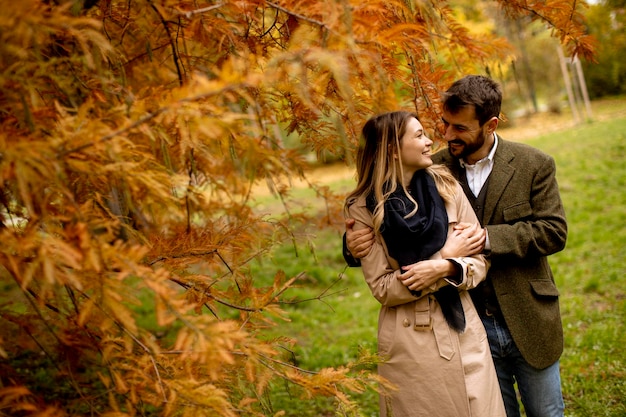 Foto pareja joven en el parque de otoño