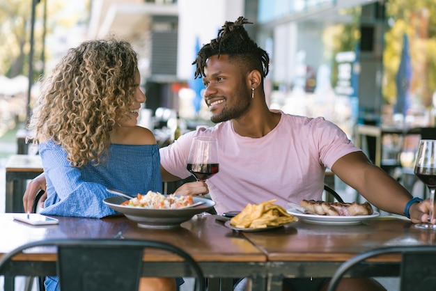 Pareja joven pasar un buen rato juntos y disfrutar mientras almuerza en un restaurante.