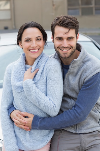 Pareja joven sonriendo a la cámara