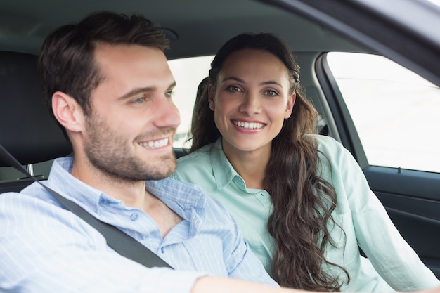 Pareja joven sonriendo a la cámara