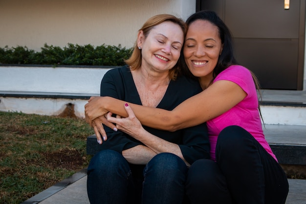 Pareja de lesbianas en el amor con el fondo de la casa