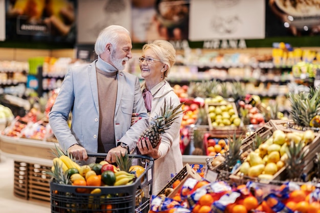 Pareja mayor comprando frutas en el supermercado