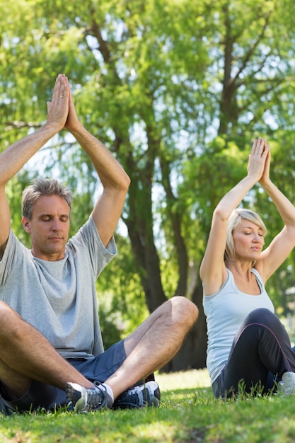 Foto pareja meditando en el parque