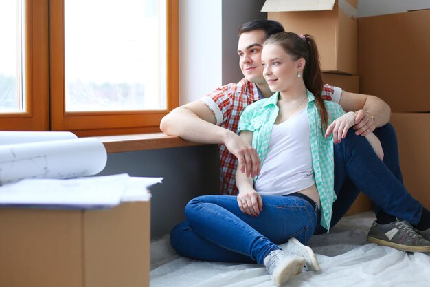 Foto pareja, mudanza, en, casa, sentado, en, el, piso