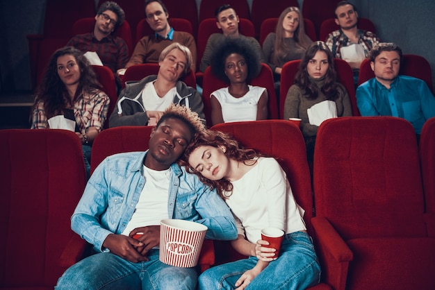 Pareja multiétnica en el amor está durmiendo en el cine