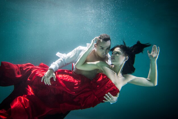 Pareja nadando bajo el agua