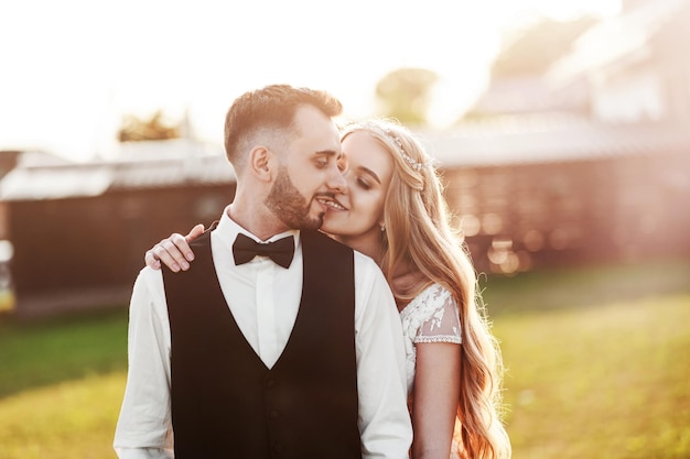 Foto pareja de novios sonriente y besándose amor y ternura de sentimiento