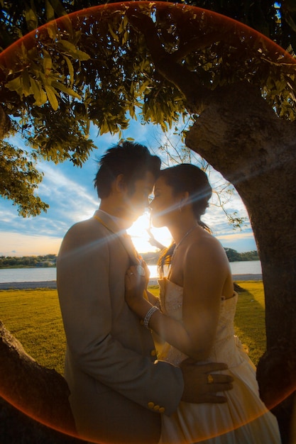 Foto una pareja de pie cara a cara en el parque durante la ceremonia de la boda