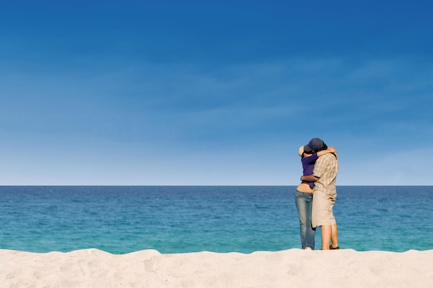 Una pareja romántica besándose en la playa del paraíso