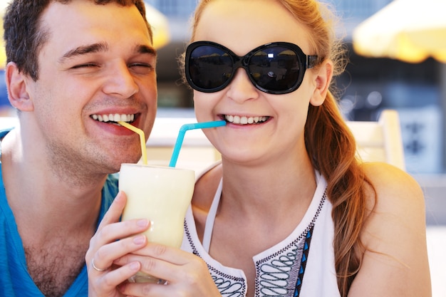 Pareja romántica compartiendo un cóctel