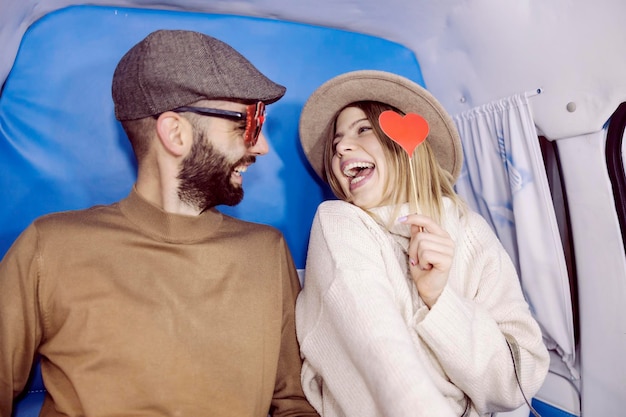 Pareja romántica divirtiéndose en la cabina de fotos