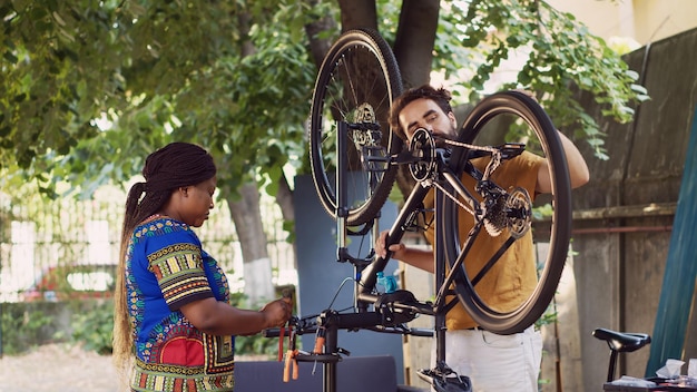 Una pareja trabajando en una bicicleta dañada