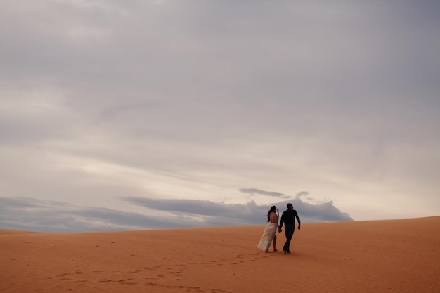 Pareja viaje duna de arena. Vista de arena y cielo