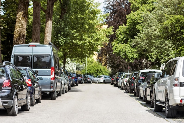 Parkplatzproblem. Belebter Parkplatz am Stau. Autos parken in der Schlange entlang des Bürgersteigs.