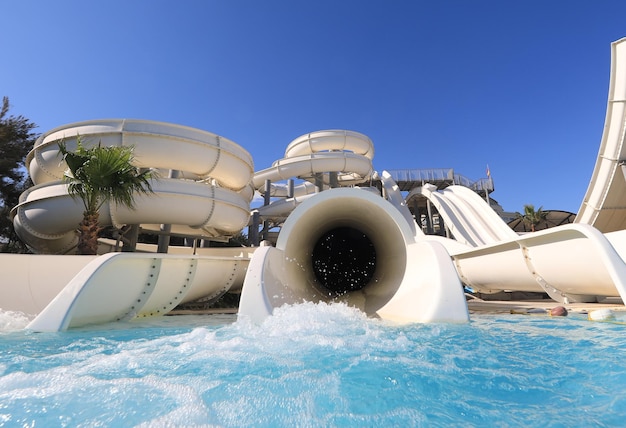 Parque acuático verano agua toboganes blancos y atracciones en el resort