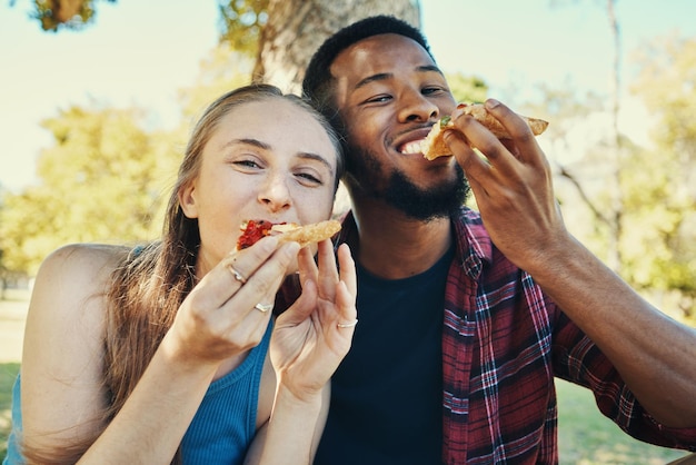 Parque de pizza e amigos ou casal comendo ao ar livre com natureza de verão e retrato feliz Picnic gen z e fast food de pessoas com fome relaxar e diversidade em um encontro no jardim juntos nas férias de verão