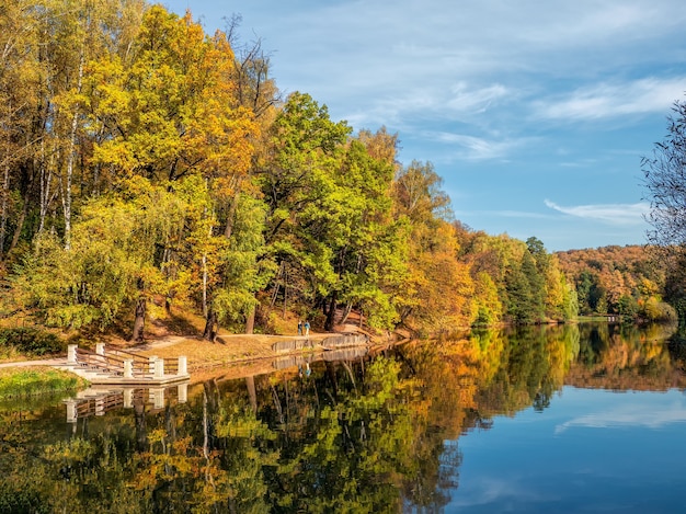 Foto parque do outono. bela paisagem de outono com árvores vermelhas à beira do lago. tsaritsyno, moscou.