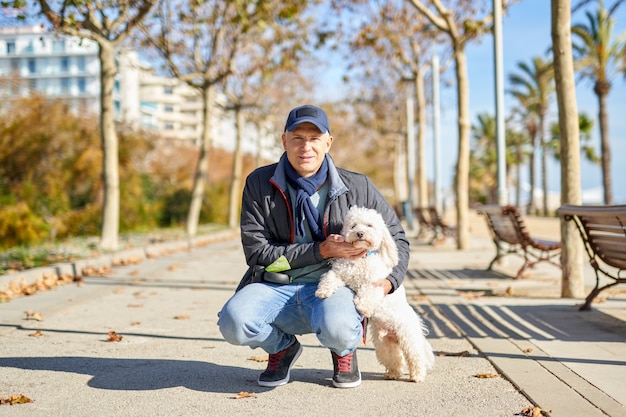 Parque de paseo de perro pequeño hombre blanco