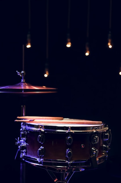 Parte de uma bateria no escuro com bela iluminação. Conceito de concerto e performance.