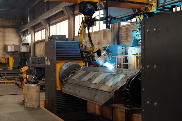 Parte de una enorme máquina industrial durante el proceso de trabajo en el taller