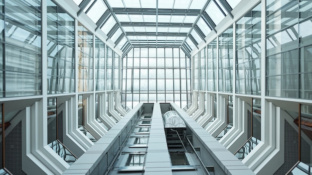 Parte del interior del centro de negocios contemporáneo o edificio de oficinas con ascensor hacia arriba y ventanas