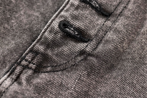 parte de jeans cosidos de primer plano de denim gris de alta calidad y detalles de denim natural del que se cosen pantalones vaqueros