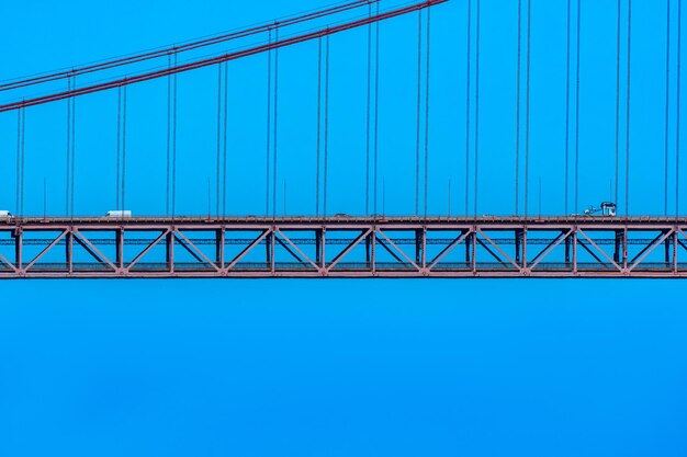 Parte del puente colgante 25 de Abril con cables de acero rojo que soportan la estructura