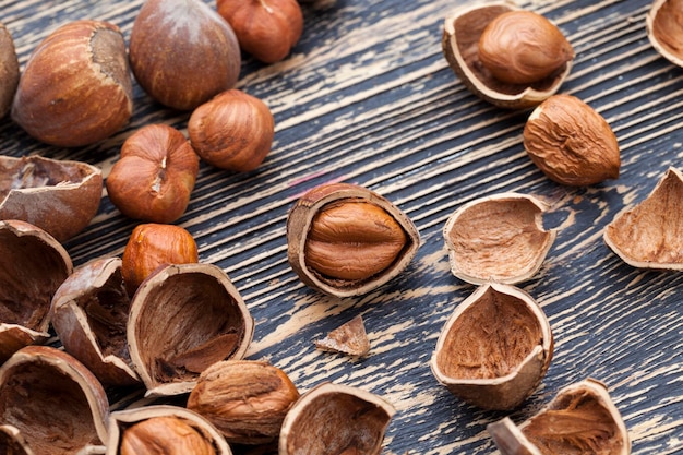 Partir las avellanas sobre la mesa, partir las cáscaras de las avellanas crudas durante la preparación de las nueces para la alimentación.