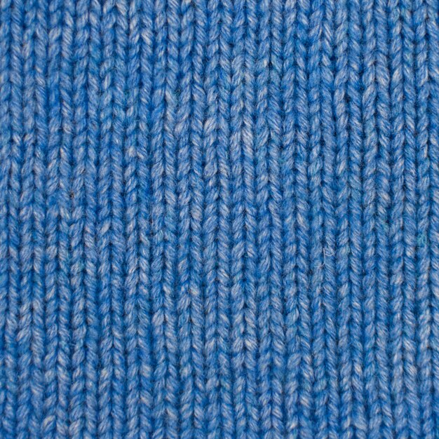 Foto pasatiempos de costura tejer tejido textil de fondo con una textura de punto lana azul textura de tejido de punto azul tejido a mano