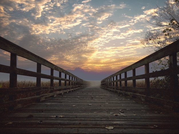 Paseo marítimo vacío contra el cielo durante la puesta de sol
